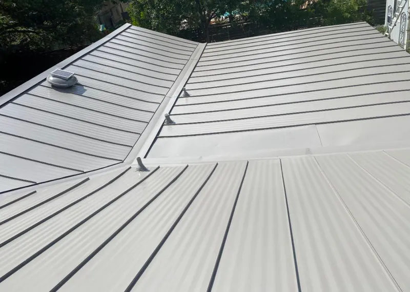Solar attic fan installed on a metal roof for Roof Ventilation in DeSoto